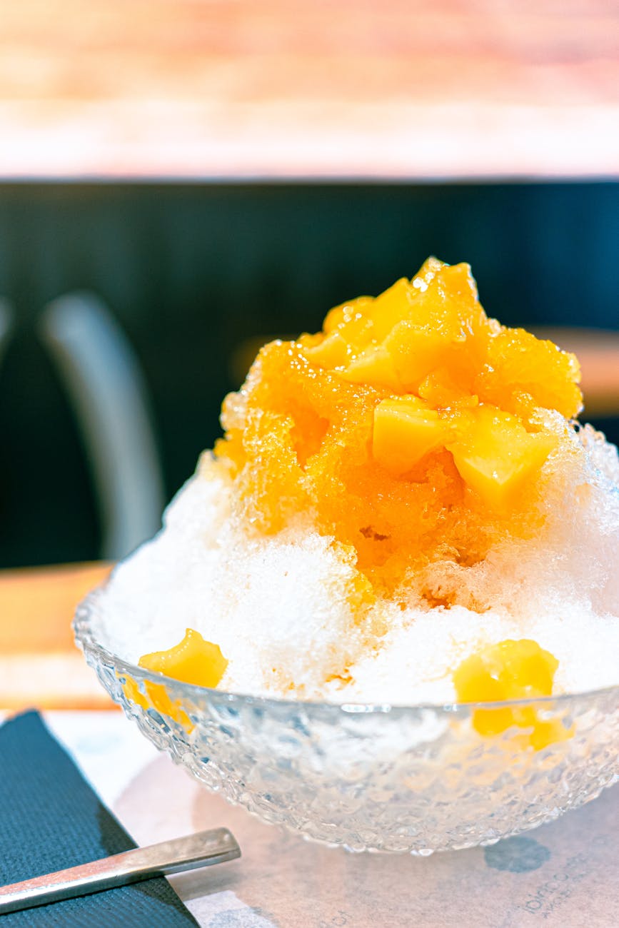 mound of mango and ice in glass bowl