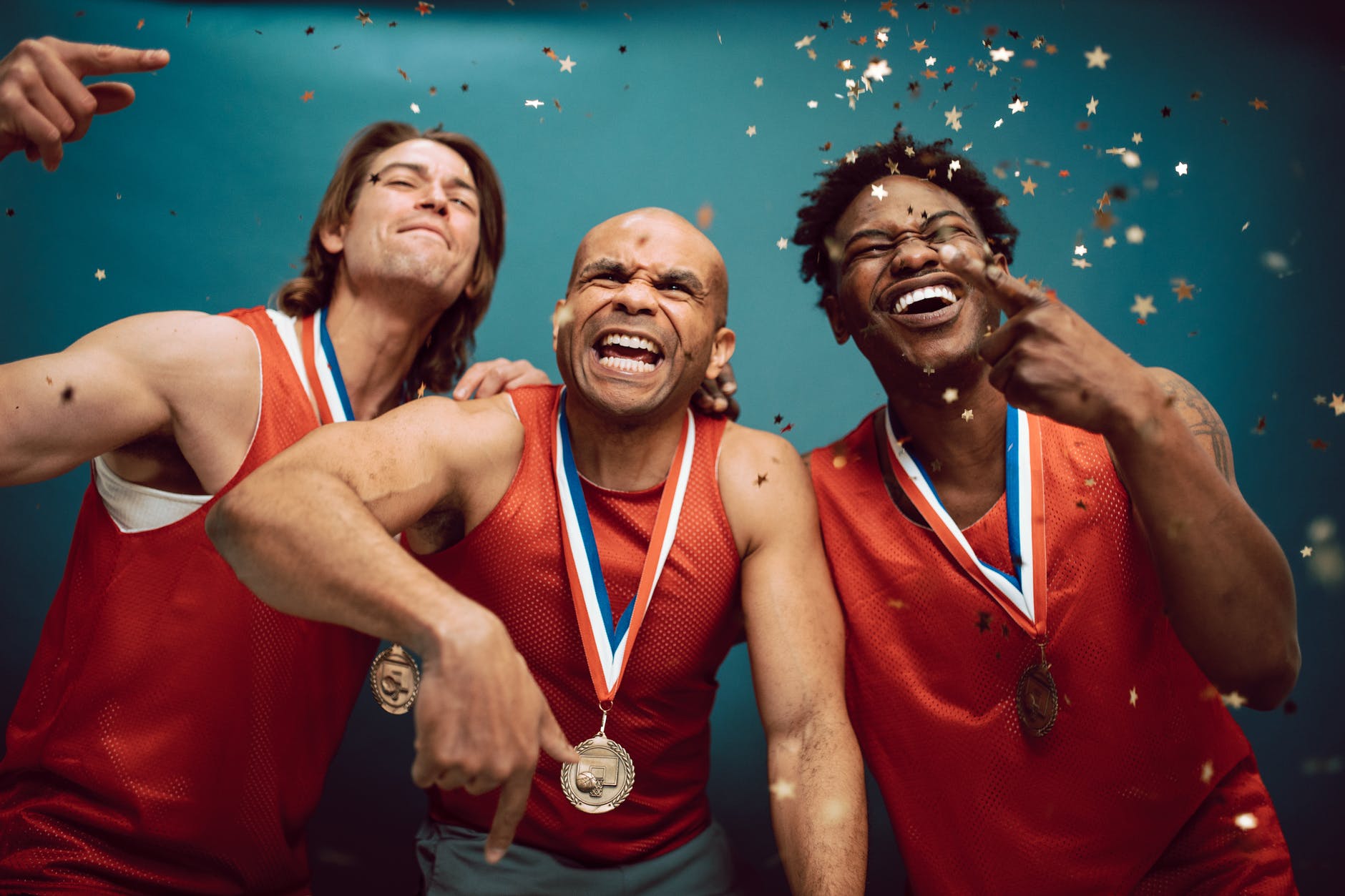 confetti falling on proud basketball players wearing medals